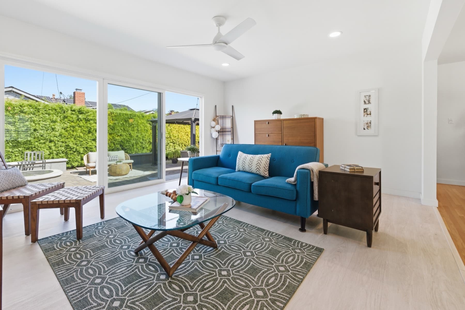 Living area with blue sofa and patio doors